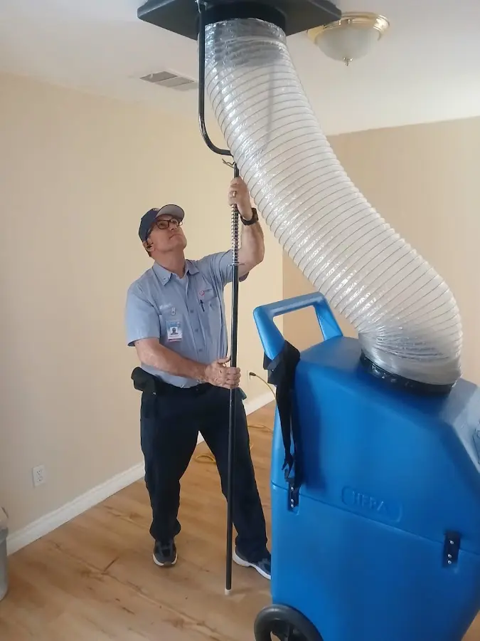 Furnace Tune-Up technician using HEPA equipment in Pensacola