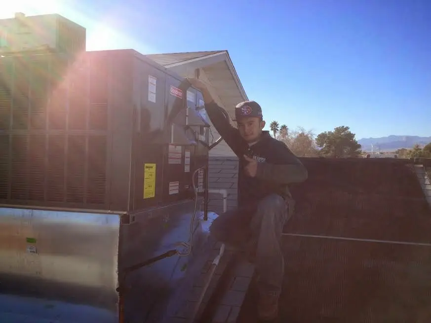 HVAC technician performing HVAC Inspection on a rooftop unit in Pensacola